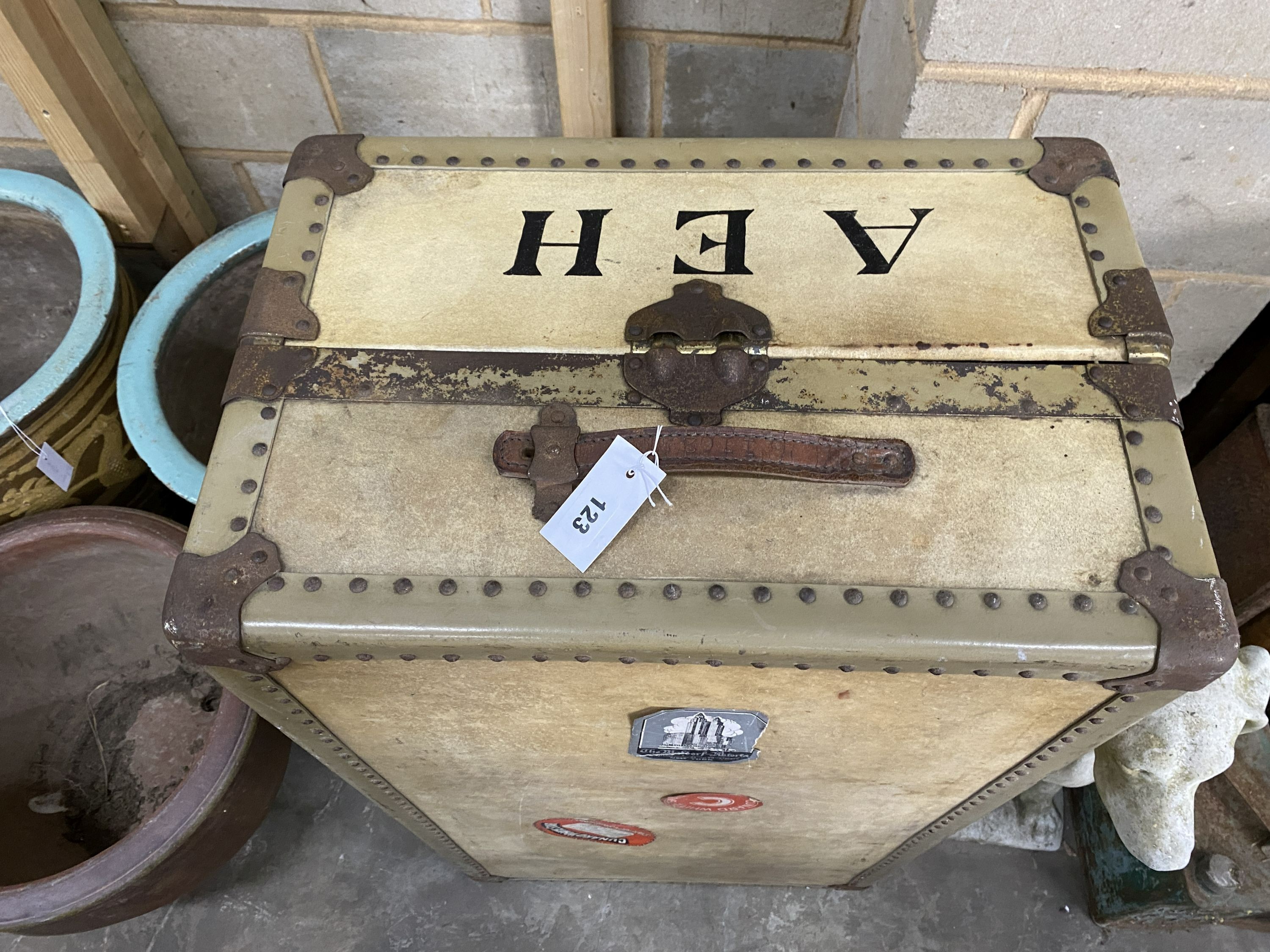 An early 20th century vellum 'Watajoy' compactum trunk, once the property of Ashley Havinden, bears Queen Mary voyage label, width 104cm
